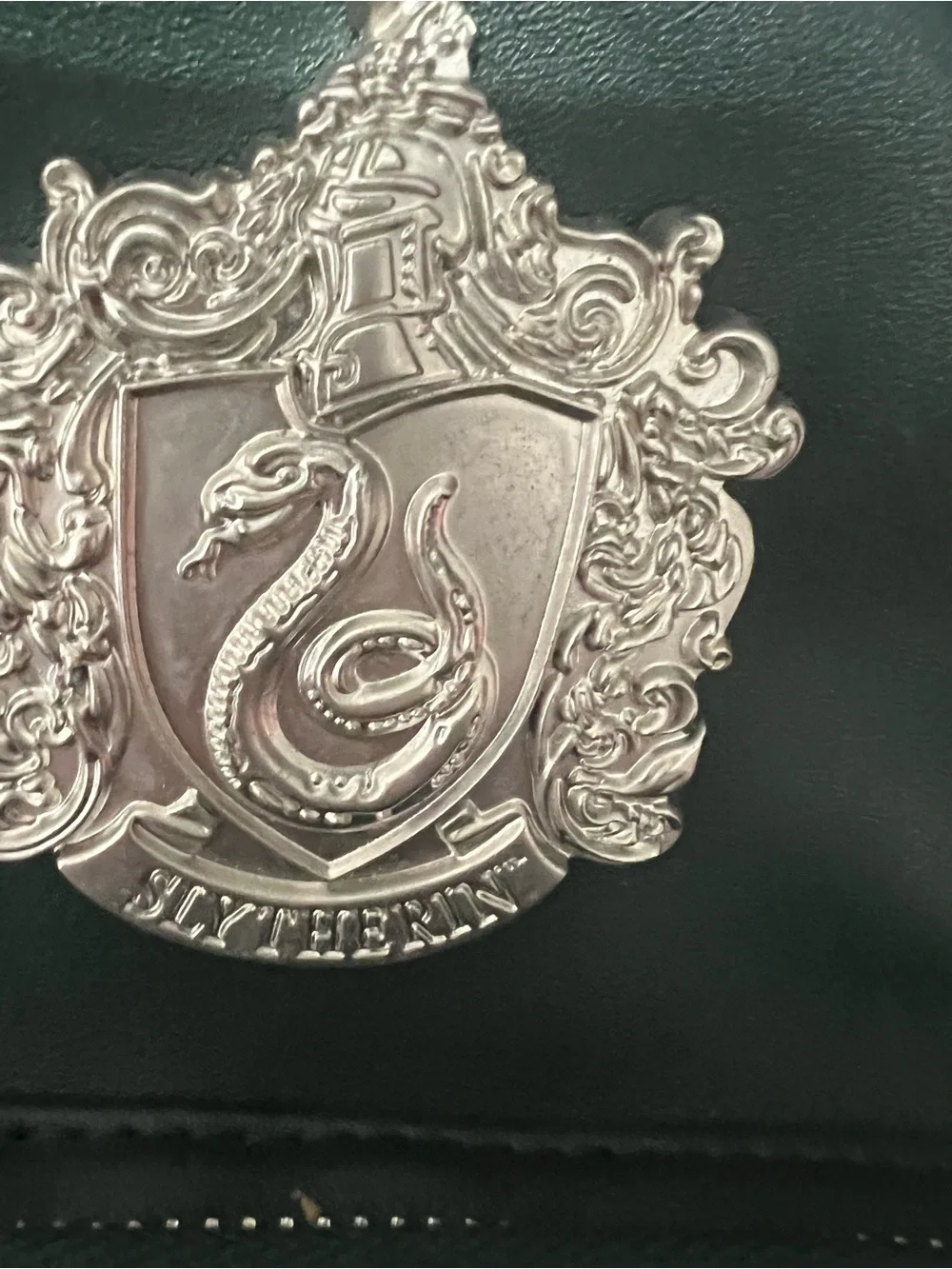 Dark Green Mini Backpack with Silver Crest Detail